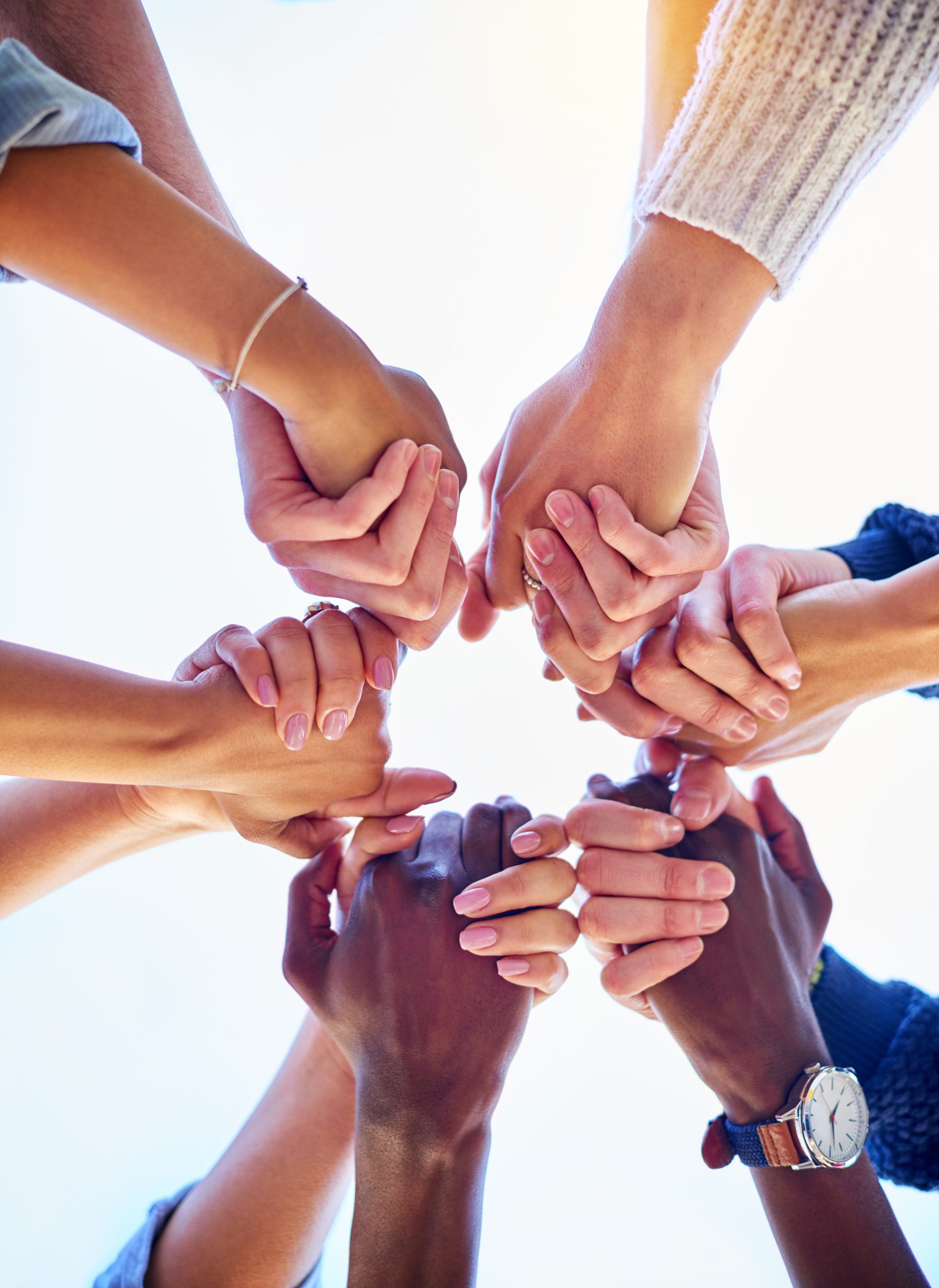 Holding hands, diversity and support from below with people in nature and solidarity or trust in backyard. Community, friends and together in garden for teamwork and success or achievement outdoor.